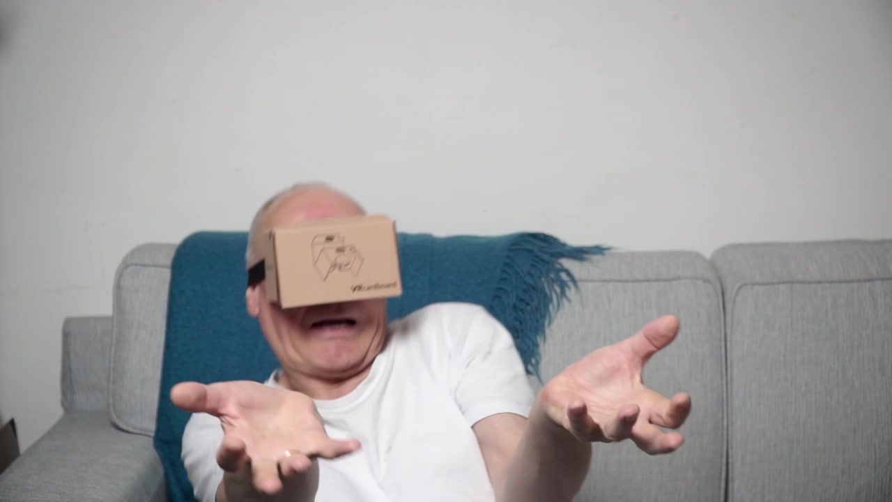 An older man uses a virtual reality headset.