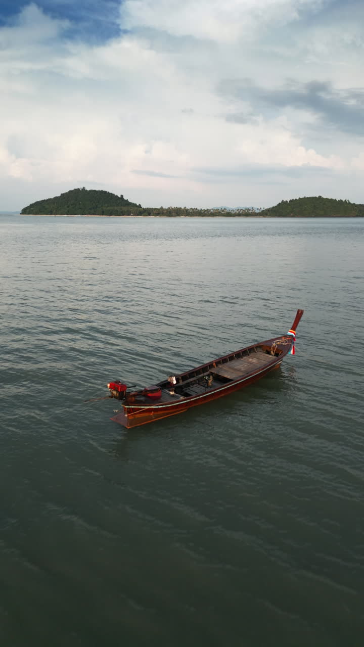 Tranquil Bay with Longtail Boat and Islands