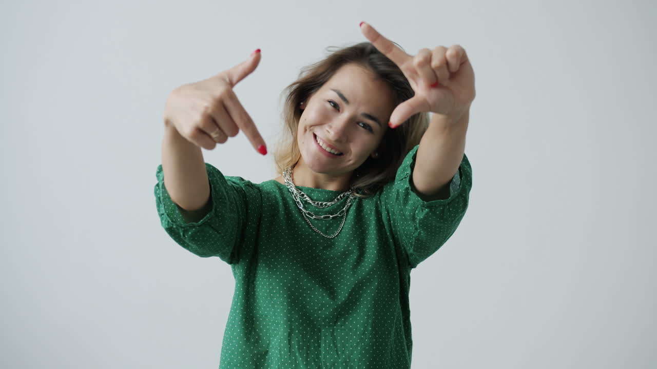 Woman Posing and Framing a Shot