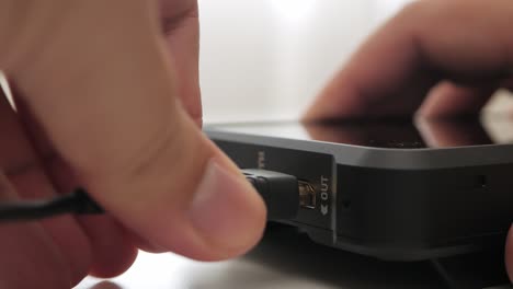 man hand plug and unplug hdmi cable into external monitor closeup