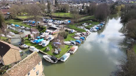 Boats-moored-on-Great-river-Ouse-St-Neots-Cambridgeshire-UK-reveal-Aerial-footage