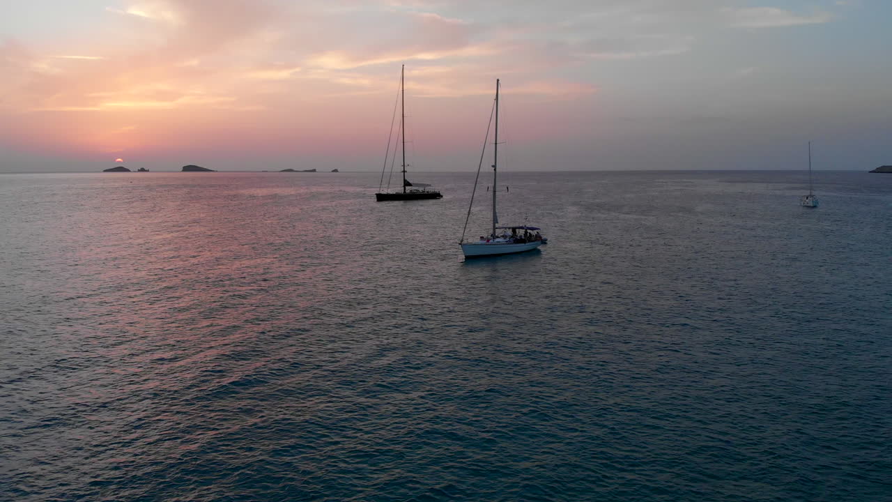 Drone footage: Multiple boats on the sea in Formentera (sunset)