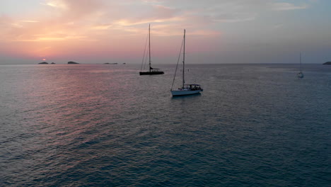 drone footage: multiple boats on the sea in formentera (sunset)