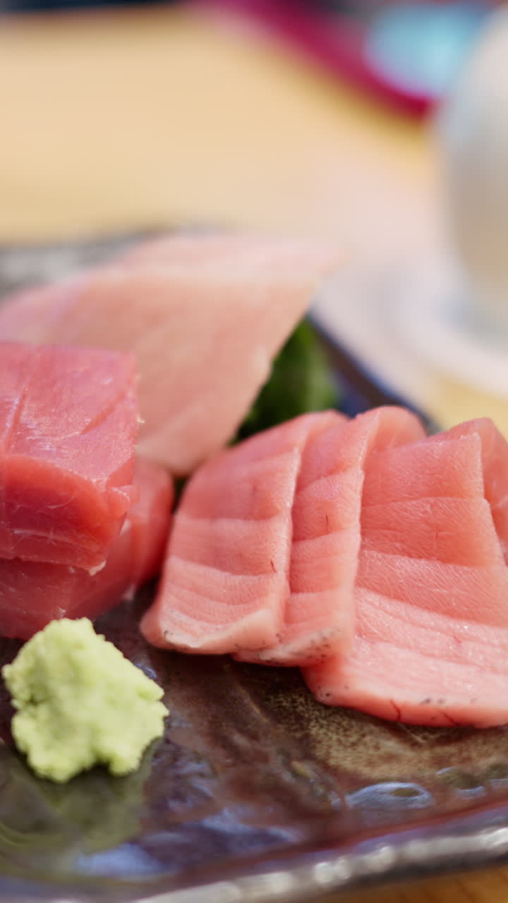Close up of multiple pieces of tuna on display at the Tsukiji Fish Market in Japan. Vertical