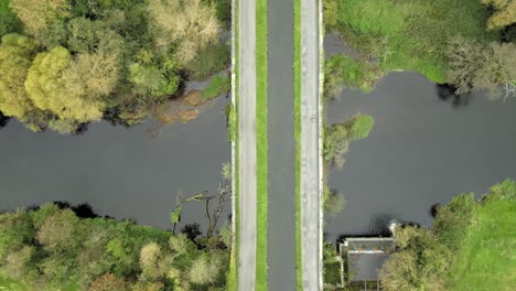 narrow green grand canal at river liffey kildare ireland drone aerial