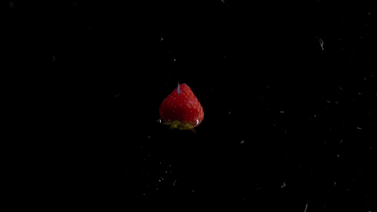 Strawberry Falling into Water Super Slowmotion, Black Background, lots of Air Bubbles, 4k240fps