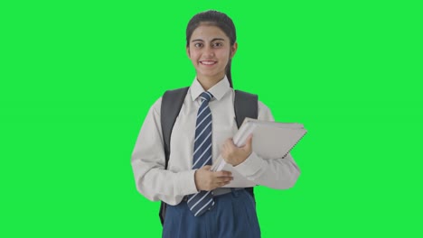 Happy-Indian-school-girl-standing-with-books-Green-screen