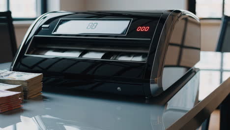 modern black money counting machine on a table
