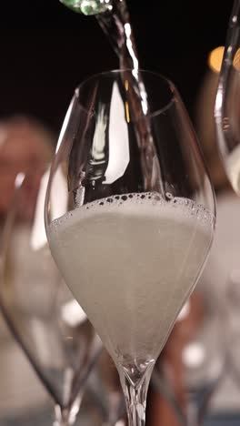 champagne pouring into flute glass