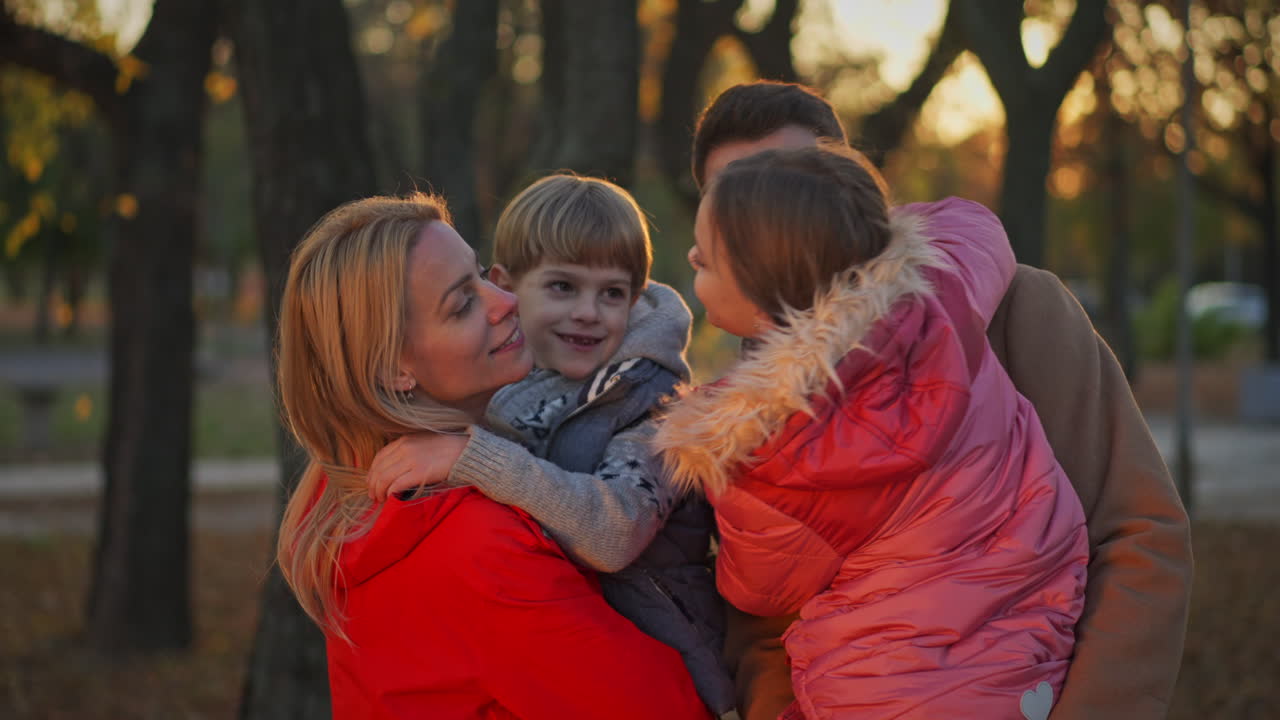 Happy family enjoying time together in the park during autumn
