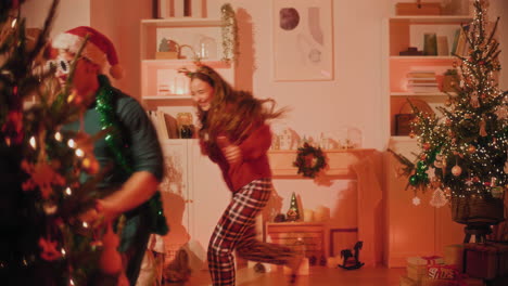 young man enjoys dancing with female friends at home