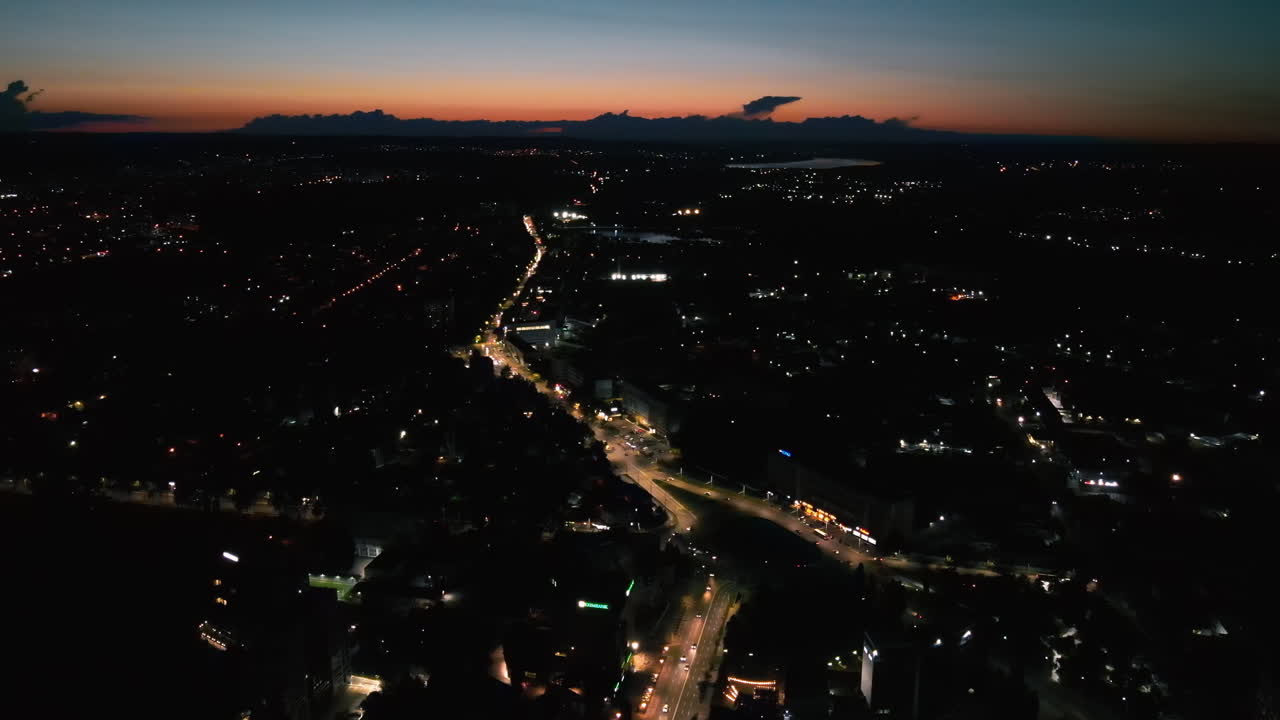 Aerial drone view of Chisinau downtown at night. Roads with moving cars and illumination. Moldova