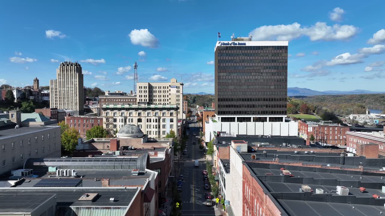 Rising drone shot of America downtown with junction on sunny day. PLDR building in center of city. Sunny day in fall season. Wide shot.