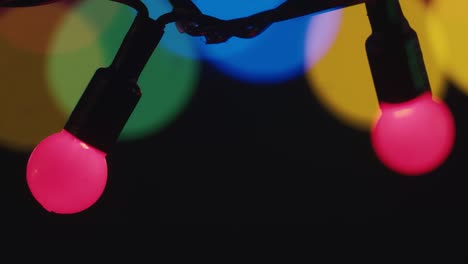 close-up of the multicolor blinking christmas lights garland on dark background