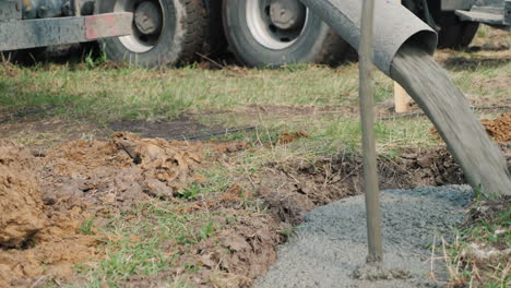 concrete flows through the pipe into the foundation of the basement construction of cottages concept