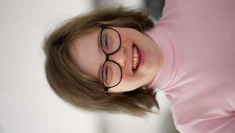 kid smiling at camera at home. a person with special needs