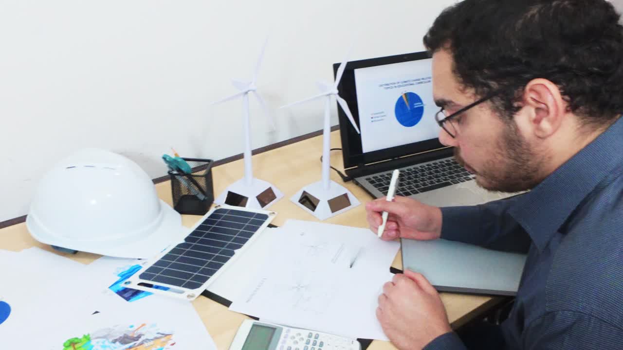 Engineer Sketching a Detailed Blueprint of a Wind Turbine