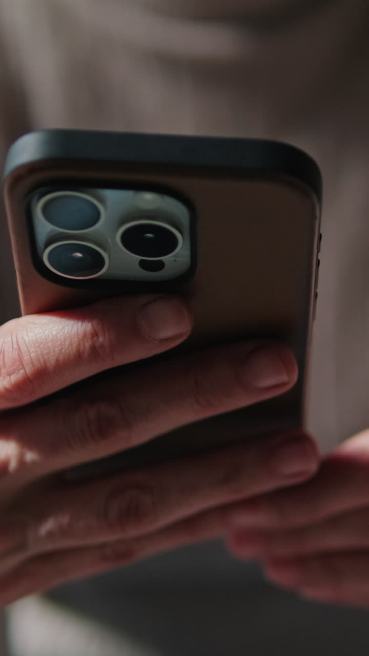 Close-up of Person's Hands Holding and Using a Smartphone