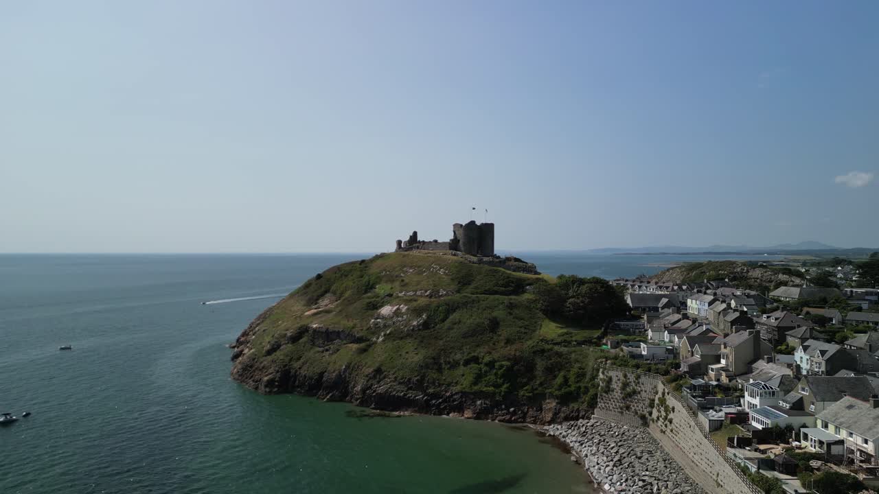 Stunning Criccieth Castle on a lovely summer afternoon - aerial drone fast approach from far - North Wales, UK