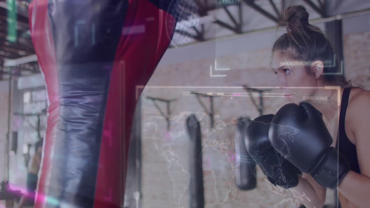 Female boxer raising gloved hands into guard stance and jabbing heavy bag for fitness training