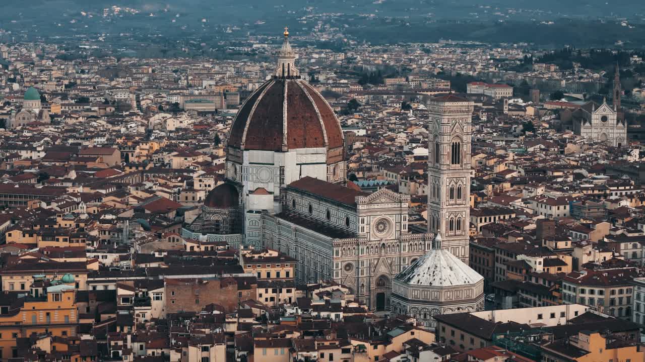 Aerial circle left around Florence Duomo with deep red rooftops and cloudy sky