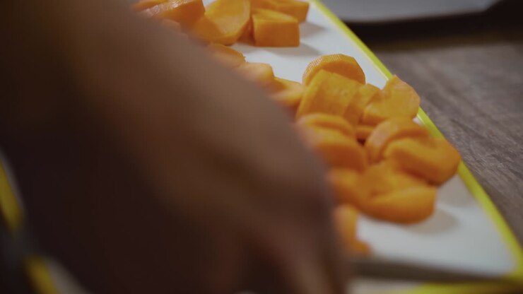 Man hands cutting vegetables for cooking dinner. Carrots ingredient for stew ragout. Kitchen interior. Male cutting carrots. Vegetable food, natural food ingredients. Daily routine of modern person.