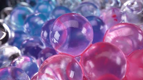 macro view of glass spheres wet with red and blue paint, abstract background 4k, blue vs red reflections