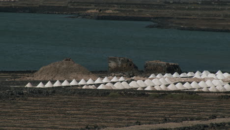 scenery of salinas de janubio with piles of extracted salt lanzarote