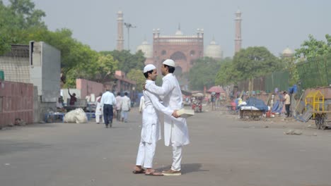 young muslim men sharing gifts at a mosque and celebrating eid