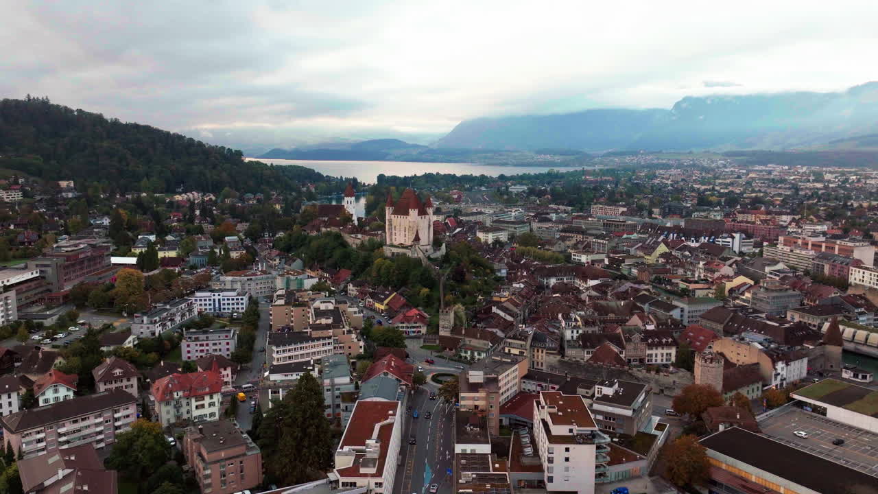 Aerial cinematic drone downtown Thun Switzerland lake cars Swiss village city downtown stunning Thun Castle Dukes of Z&auml;hrigen Interlocken Bern Jungfrau cloudy sunrise sunset backward slowly movement