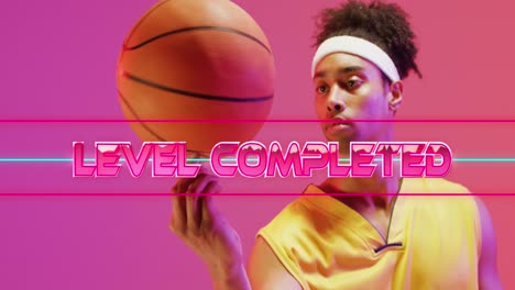 Animation-of-level-completed-text-over-neon-pattern-and-biracial-basketball-player