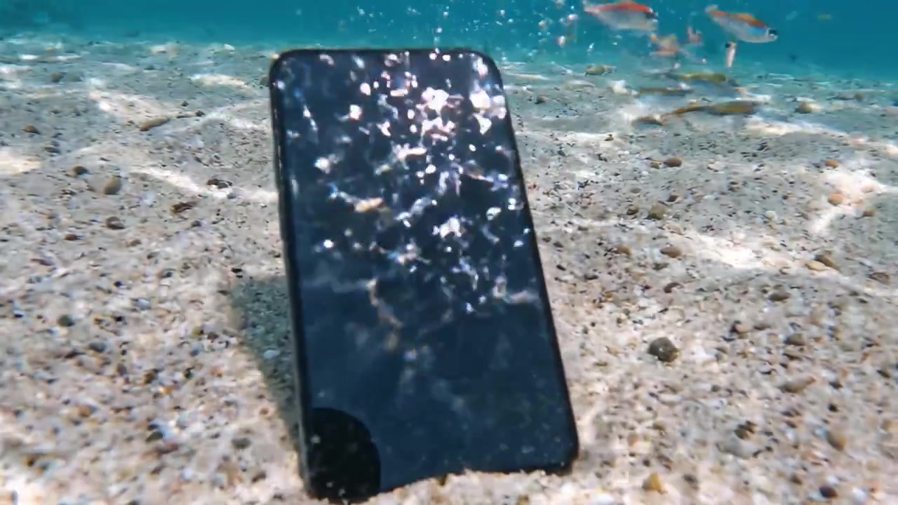 A Smartphone Submerged Underwater, Capturing Unique Perspectives of the Ocean Floor and Bubbles in a Mysterious Aquatic Environment