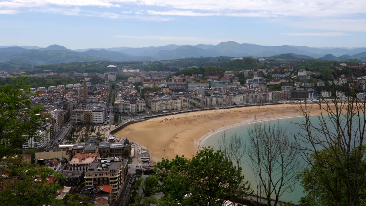 Aerial panoramic shot of beautiful skyline in San Sebasti&aacute;n during sunny day in Spain - Beautiful mountain range and cityscape in background