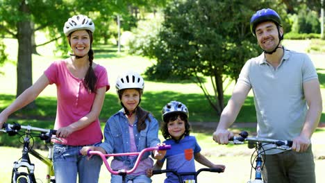 happy family on a bike ride in the park together
