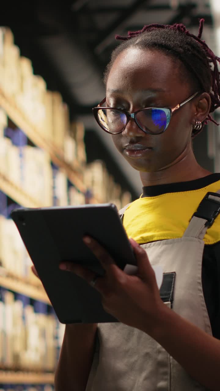 Vertical Video African american employee applies shipping labels tags on cargo boxes
