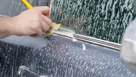 cleaning car trim with a detailing brush