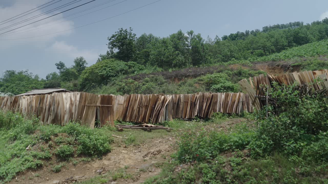 Wooden Panels Drying in Rural Landscape