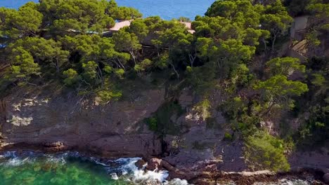 flying down close to the cliffside of the mediterranean sea