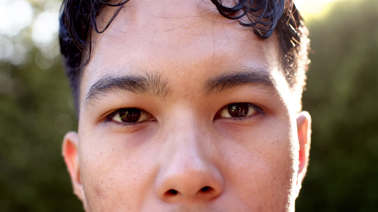 Close-up of man with focused expression outdoors