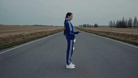 teenage girl with energy ball on road