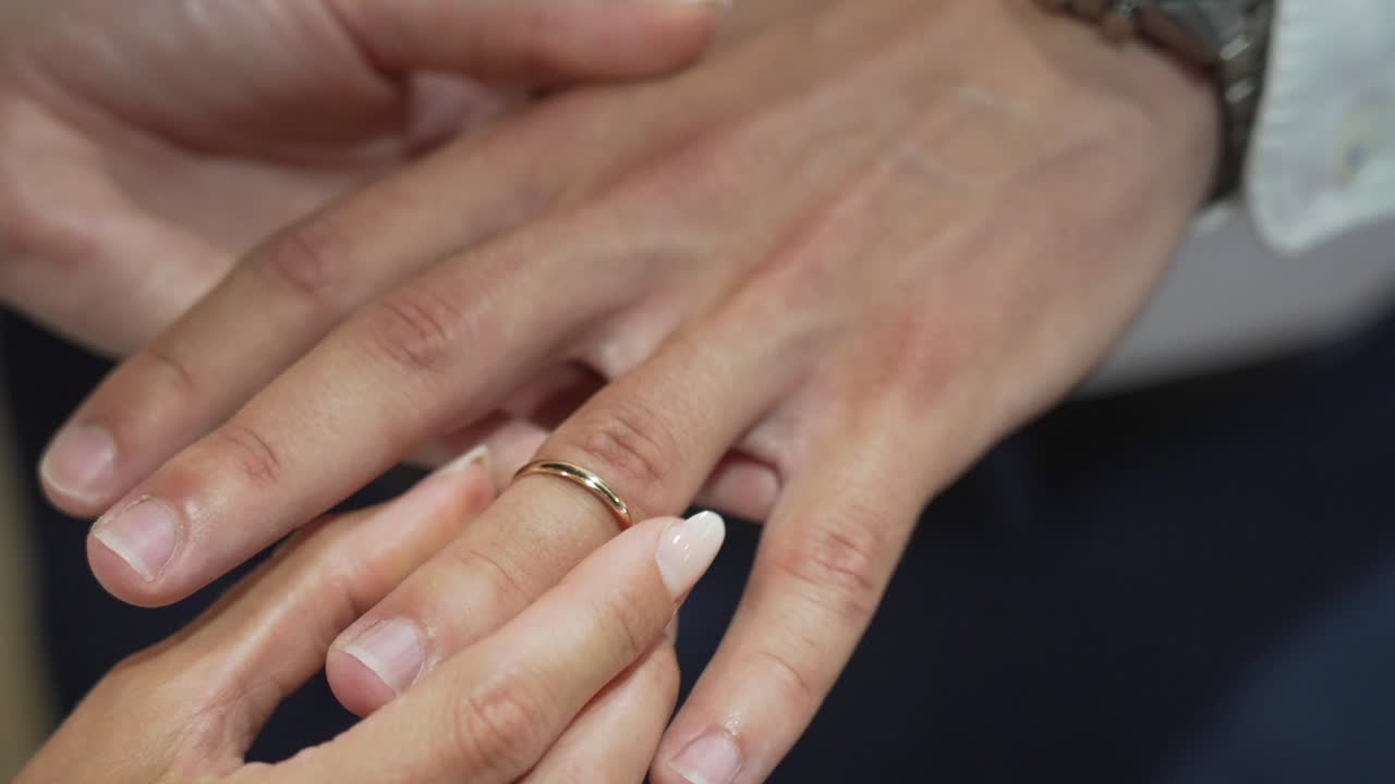 Woman engaging man couple goals detail shot of hands and rings wedding