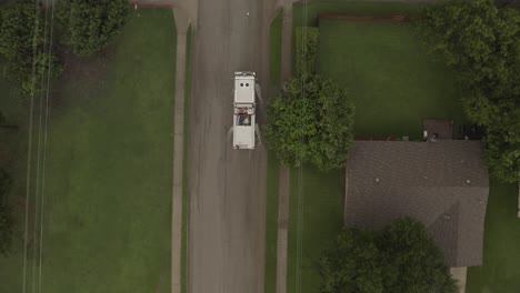 A-fire-engine-slowly-passes-a-red-car-on-a-flash-flooded-street