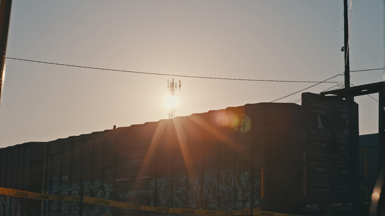 Freight Train Moving in Slow Motion During Golden Hour with Sun Flares Cinematic