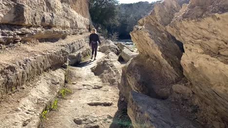 Slow-motion-shot-of-a-woman-hiking-on-some-trails-in-Austin,-TX