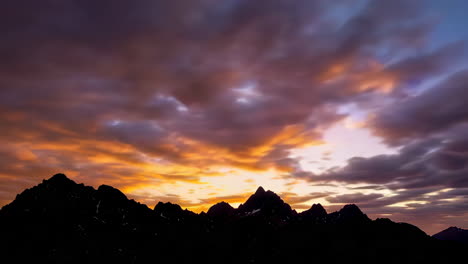 mountain peaks at sunset/sunrise with dramatic clouds