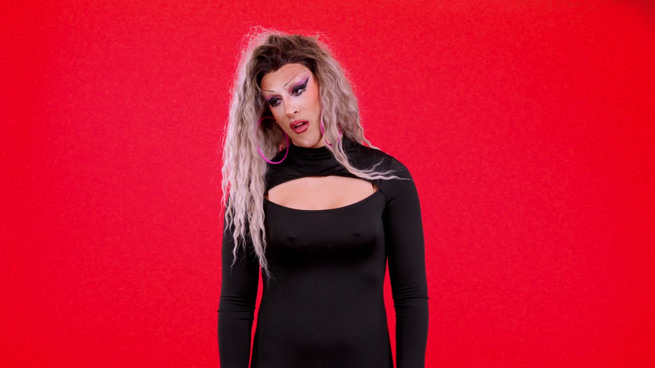 Drag Queen in Black Dress against Red Background