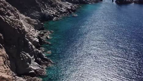 mykonos blue water on cliff face