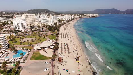 Aerial-View-of-Cala-Millor-Beachfront-Mallorca-Island-Summer-Holiday-Destination-on-Mediterranean-Sea,-Drone-Shot