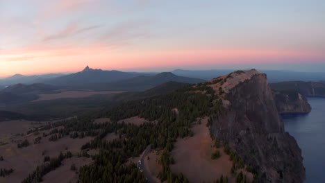 aerial slider shot over the rim of crater lake at sunset