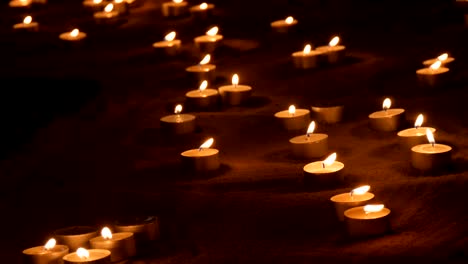 candles burning in sand